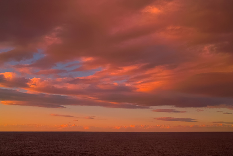 夕焼け雲と黒い水平線の写真画像