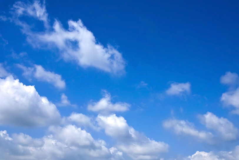 澄み切った青空に綿雲が浮かぶの写真画像