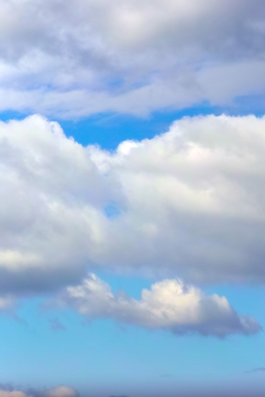澄み渡る青空を遮る大きな雲の写真画像