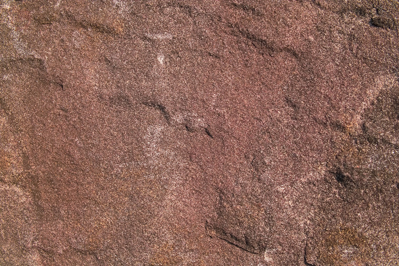 赤茶色の滑らかな岩肌の写真画像