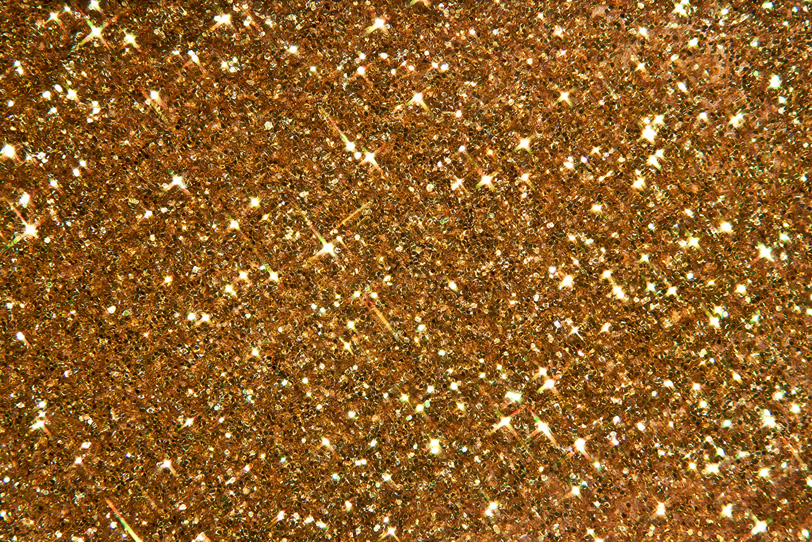 キラキラと輝くレッドゴールドのグリッターの写真画像