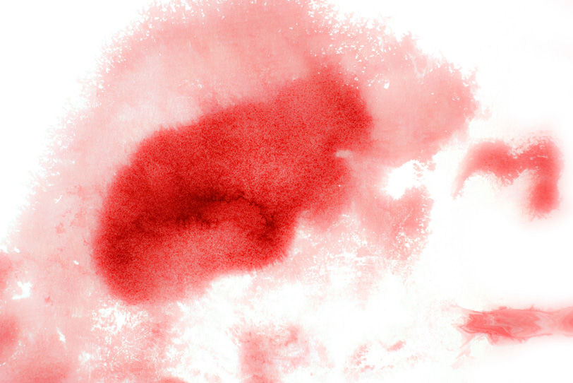 赤い水彩がにじむテクスチャの写真画像