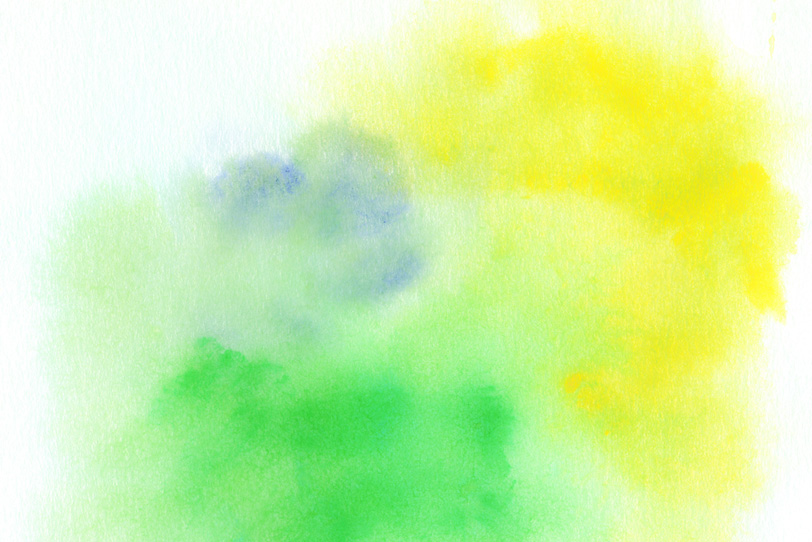 紙に滲む黄色と緑色の水彩の写真画像