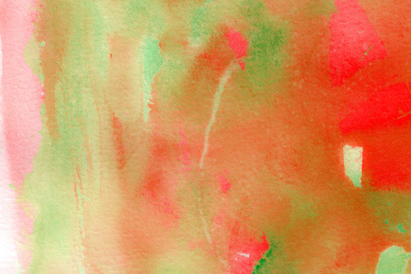 水彩紙に赤と緑がにじむテクスチャの写真画像