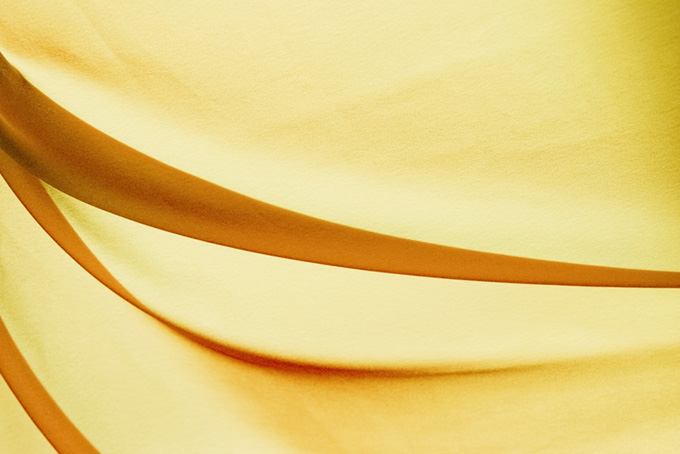 硬いドレープがある黄色い布地の素材（布 壁紙の背景フリー画像）