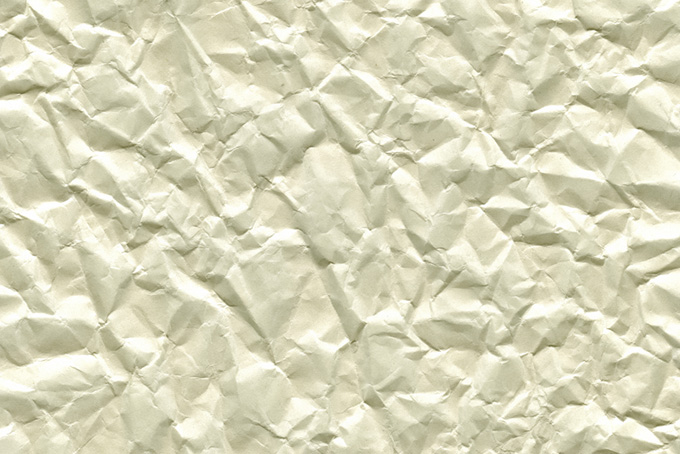 シワの寄った生成り色の紙の背景（紙 素材の背景フリー画像）