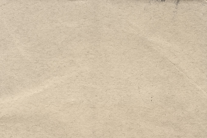 繊維が散りばめられた紙の写真（紙 素材の背景フリー画像）