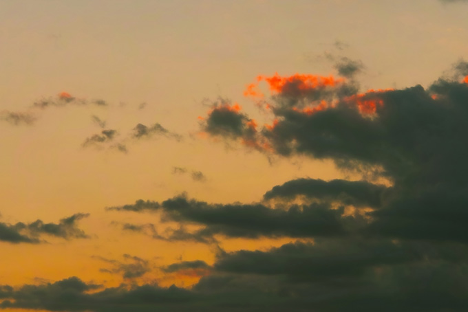 黒雲が漂う淡い夕焼け（空 おしゃれの背景フリー画像）
