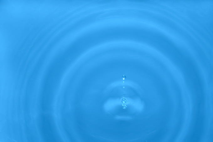水滴と広がる大きな波紋の写真（水 写真の背景フリー画像）